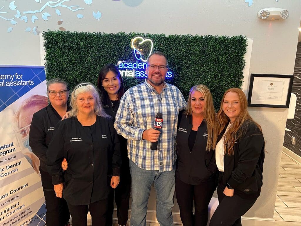 Charley Belcher filming for his show with the staff of Academy for Dental Assistants